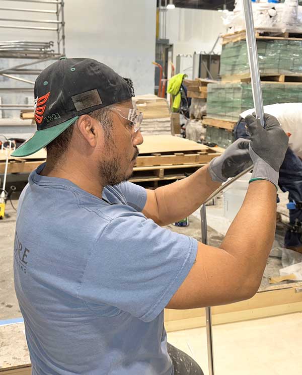 Flooring-worker-bending-metal-trim-photo