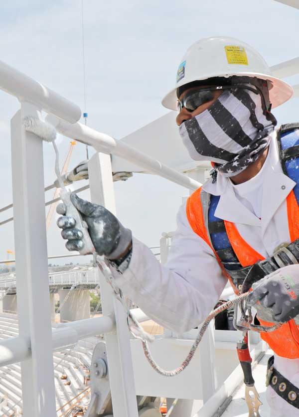 photo-of-painter-rolling-paint-on-handrails